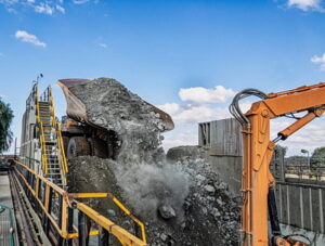 Huge truck unloading kimberlite in a crusher in an open pit diamond mine , in Botswana
