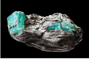 An emerald gemstone in organic condition