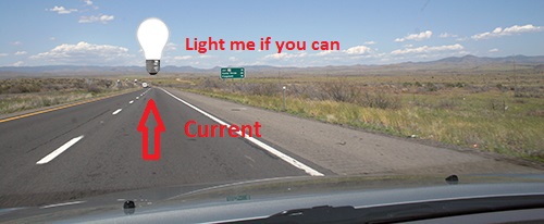 Car on road with arrow pointing to light bulb