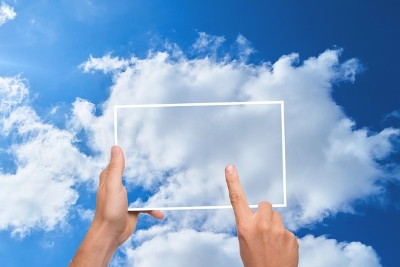 Outline of a computer screen wiht a cloud behind it